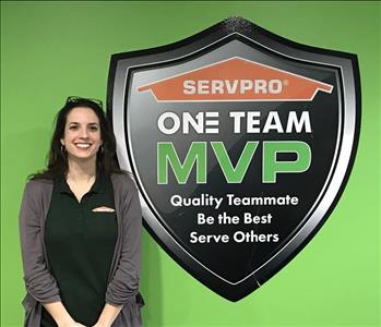 Female employee standing by SERVPRO sign