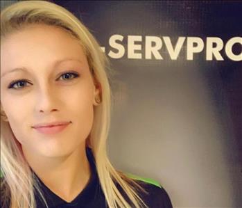 Female Crew Chief Jasmine standing in front of a SERVPRO banner