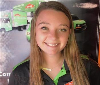 Girl standing in front of SERVPRO sign